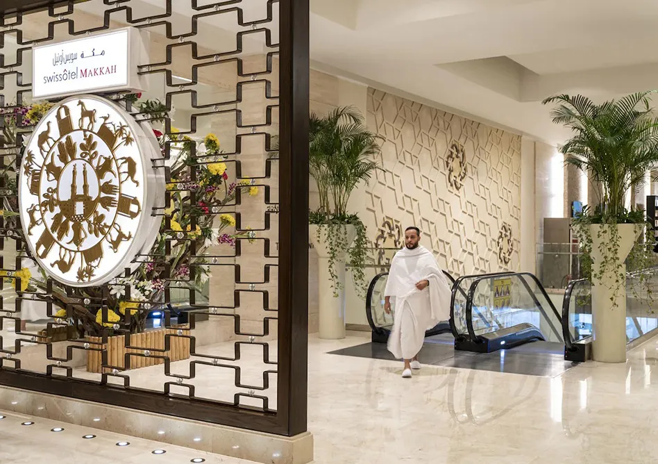 Swissôtel Makkah entrance with a pilgrim walking in Ihram