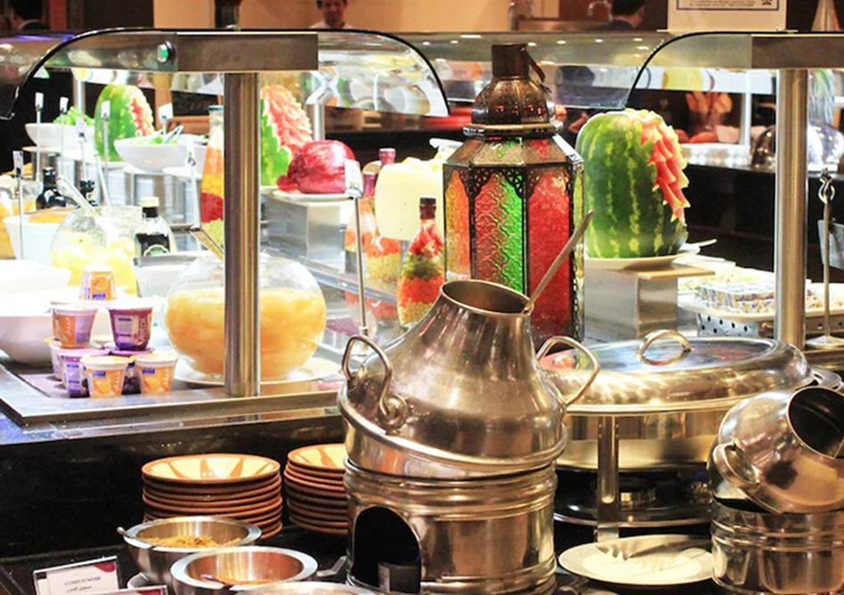 Buffet display with food, drinks, and colorful lanterns