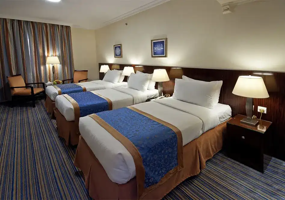 /media/umrah-images/3-single-beds-in-room.webp
