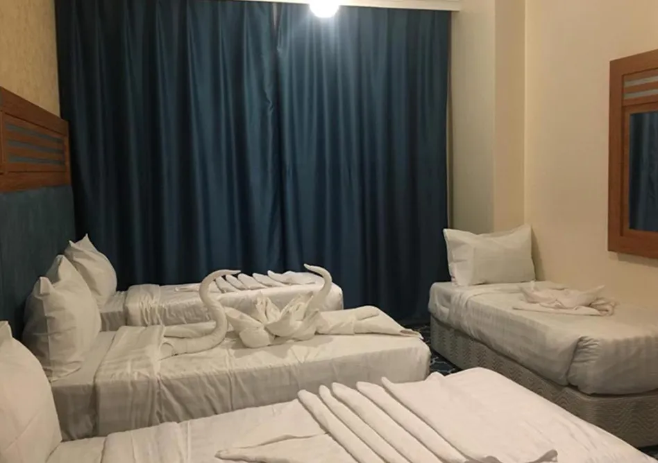 /media/umrah-images/four-single-beds-room%20%282%29.webp