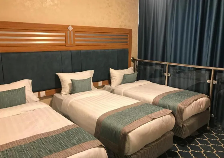 /media/umrah-images/room-with-3-single-beds-%20%281%29.webp