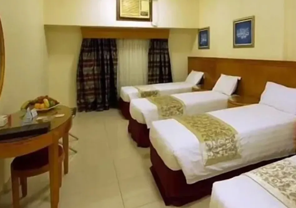 /media/umrah-images/room-with-4-single-beds%20%281%29.webp